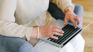 woman using laptop on knee