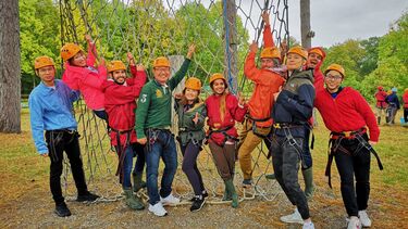 MBA students doing a high ropes activity.