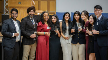 MBA Alumni smile for photo at the Prize giving ceremony before their graduation