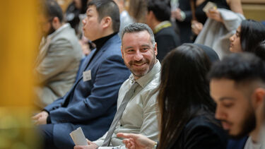 PhD Graduate smiles during ceremony