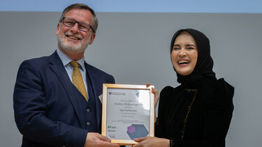 Professor Damian Hodgson presents top performer award to Analisa