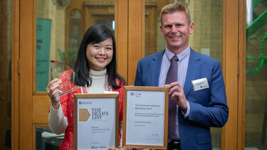 Dean Professor Fraser McLeay smiles with Dean's List winner Fransiska Sonia Rickiyanto