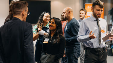 People of varying ages chat at an event