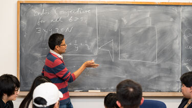 Lecturer teaching a maths class