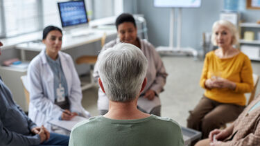 Group of patients and doctors seated in a circle