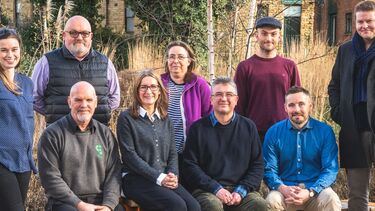 Members of the Local Nature Recovery Strategy (LNRS) Advisory Panel pose in front of trees and plants