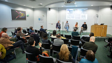 four people on stage at panel discussion