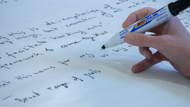 hand writing with marker pen on paper