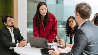 MBA students working together in a business setting.