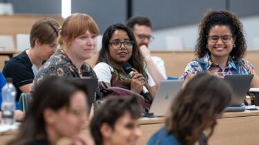 People sat in a lecture theatre looking engaged