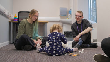Two students and a child in a Small Talk clinic session