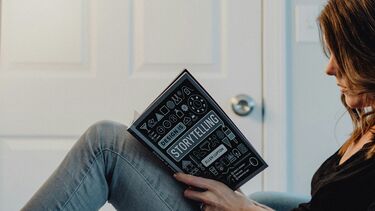 A woman reading a book sat down