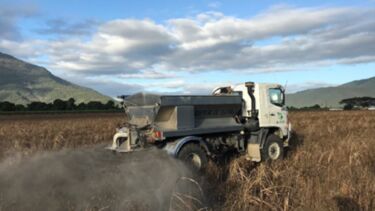 Crushed basalt being spread on the Hesp field trial plots in May 2018 prior to cultivation and planting of sugarcane (Photo: Paul Nelson).