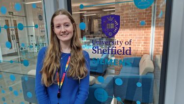 Islay Maclean in front of the University and Siemens logo 
