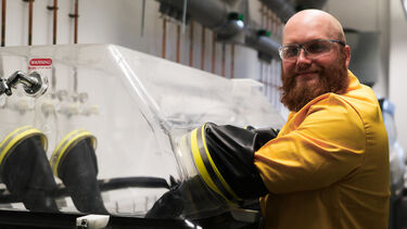 Scientist using a biological safety cabinet