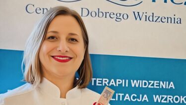 A woman with a blond bob and white coat