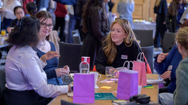 Group of women sat round a table