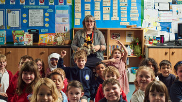Sabine Little at the front of the classroom with primary aged school children