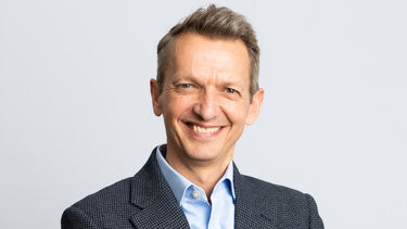 Andy Haldane stood with his arms folded, smiling