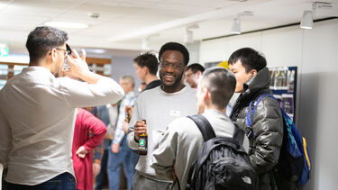 Group of men standing and talking at showcase 