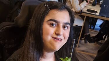 An image of Haffizah drinking a cocktail in a restaurant