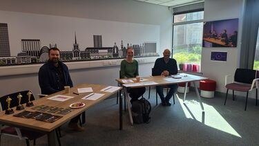 three entrepreneurs sat at desk in the start-up studio 