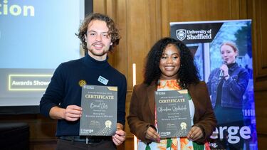 Two students posing with certificate 