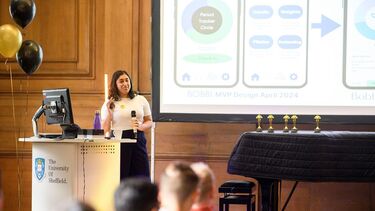 Student winner presenting on stage 