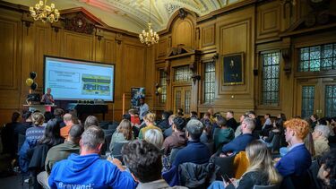 Large audience viewing presentation in grand room 