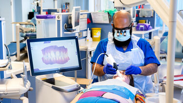 Dentistry student carrying out a procedure on a patient 