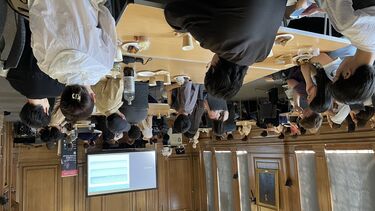 Economics students attending a slideshow presentation in Firth Hall