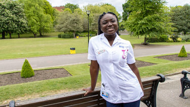 A woman in a midwifery uniform in front of Western Park