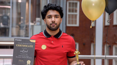 Winner standing with certificate 