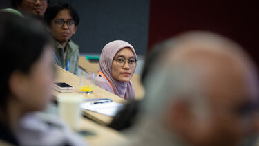 People sitting in a lecture theatre.