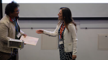 Maria Teresa Speziale awarding the best paper award for the CRAFiC stream.