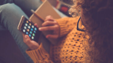 Female student browsing apps on her phone