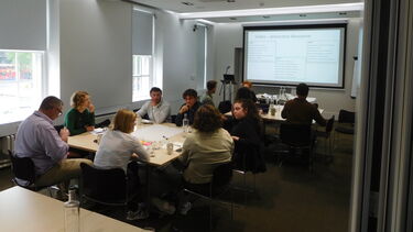 Business leaders having conversations around tables.