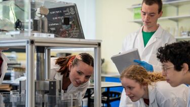 Environmental Science students conducting experiments in labs. 