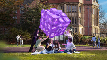 Three students in the park near University buildings