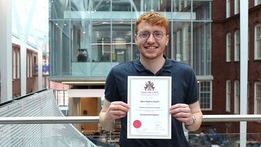Technician holding his certificate
