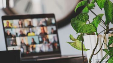 A laptop with an online meeting