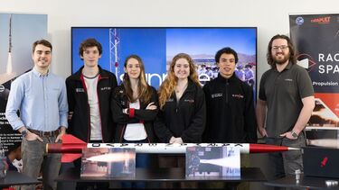 Students from Project SunRide stood with a representative from their sponsor - Labman Automation