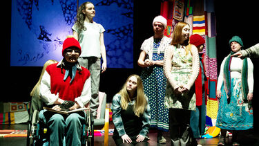 group of students on stage as part of a play