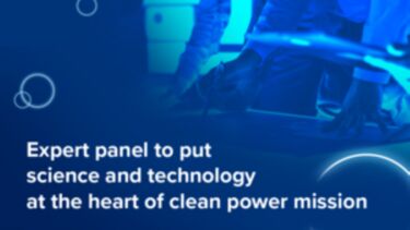 An image of multiple people's hands working on a blueprint in blue shades with white text