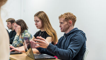 A student in a seminar speaking to their classmates