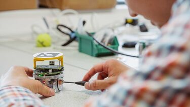 A student is assembling a small robot