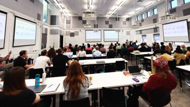 Students watching a presentation at a conference 