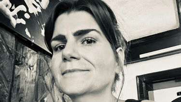 Black and white image of kirsty smiling at the camera 