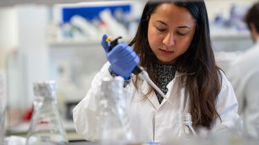Student in the lab using a pipette