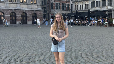 Ella standing in a public square in Utrecht